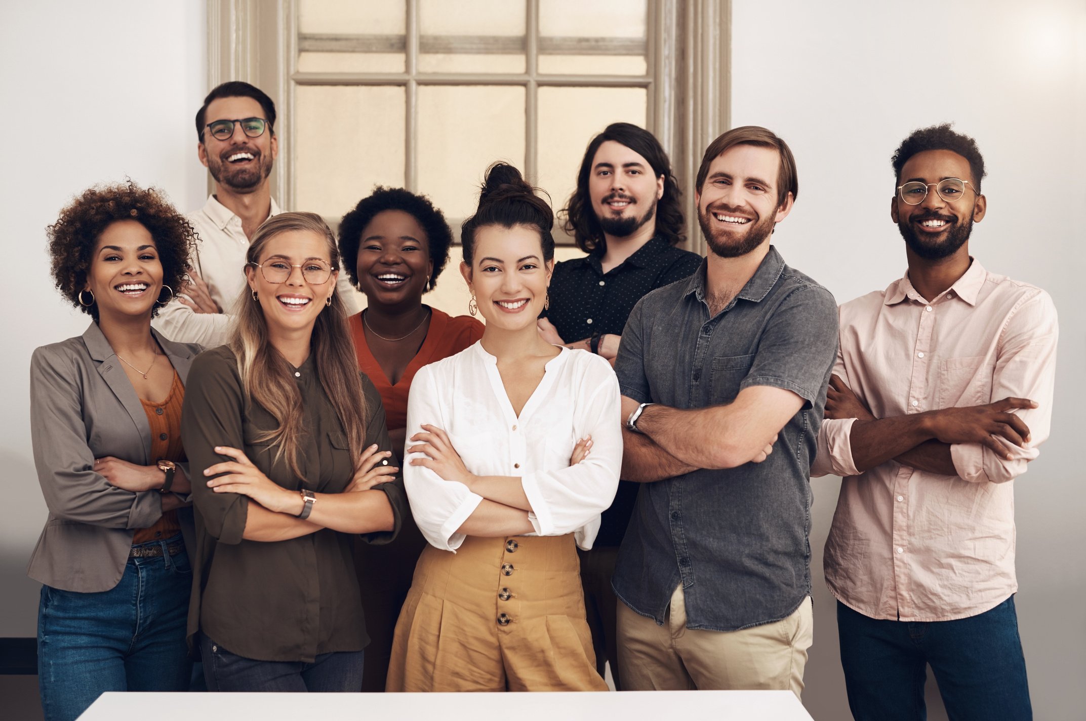 Happy, Diverse and Smiling Startup Entrepreneurs Standing Together Showing Teamwork Goals. Contact Us and Learn about Us and Our Vision, Mission and Faq from Our International Business Community